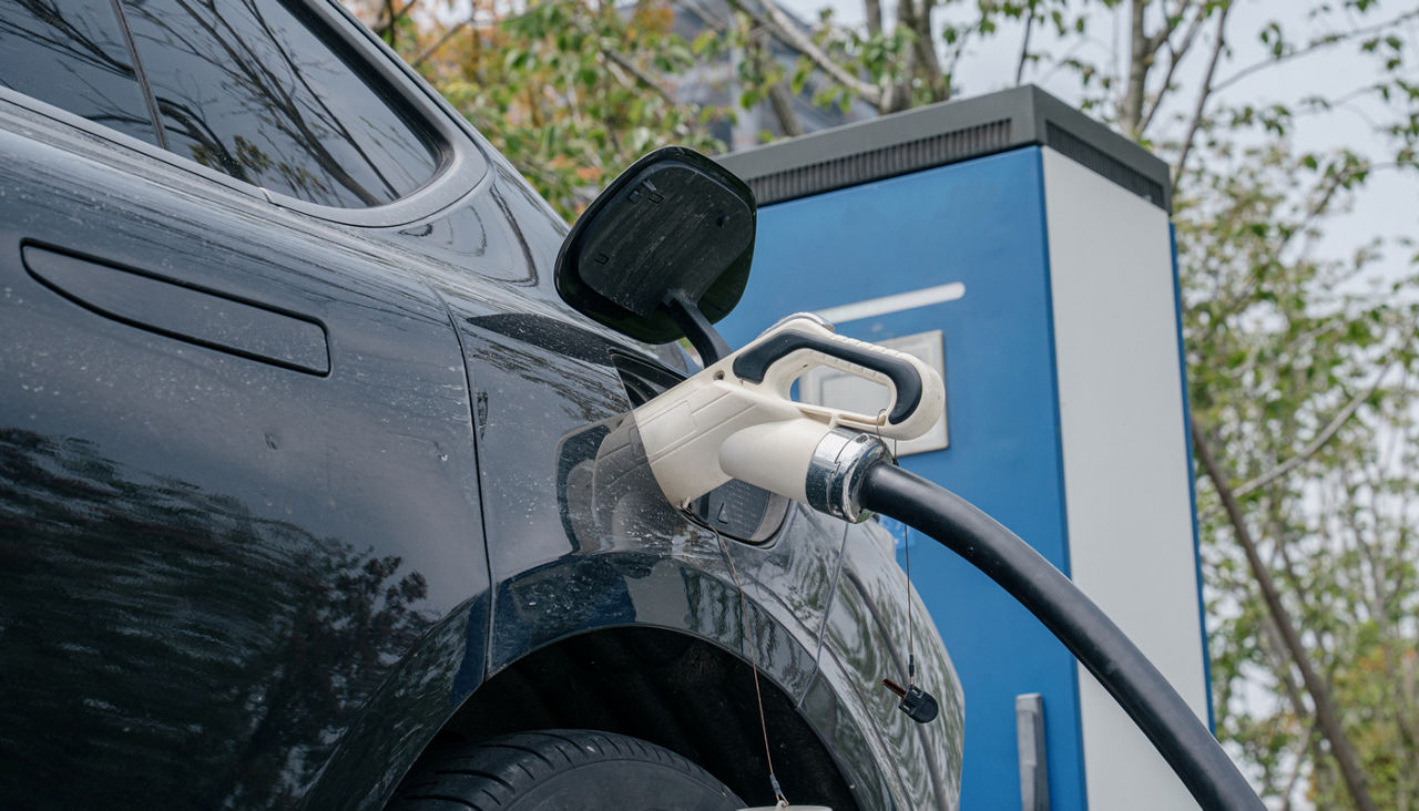 Electric car is charging in station