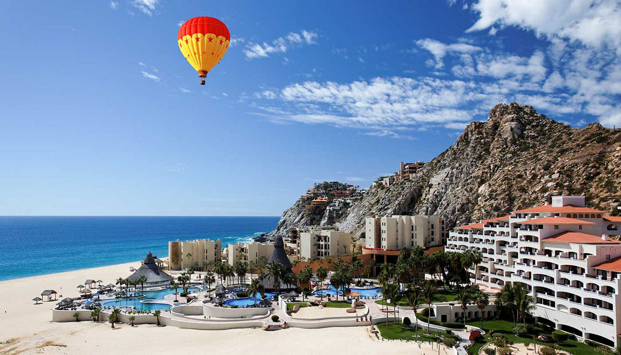 Condos and Apartments on the Beach in Cabo San Lucas, hot air balloon in the sky