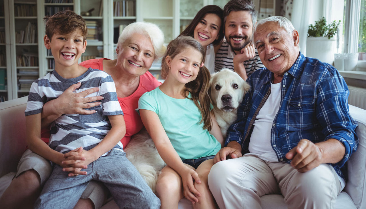 Portrait of happy family sitting on sofa