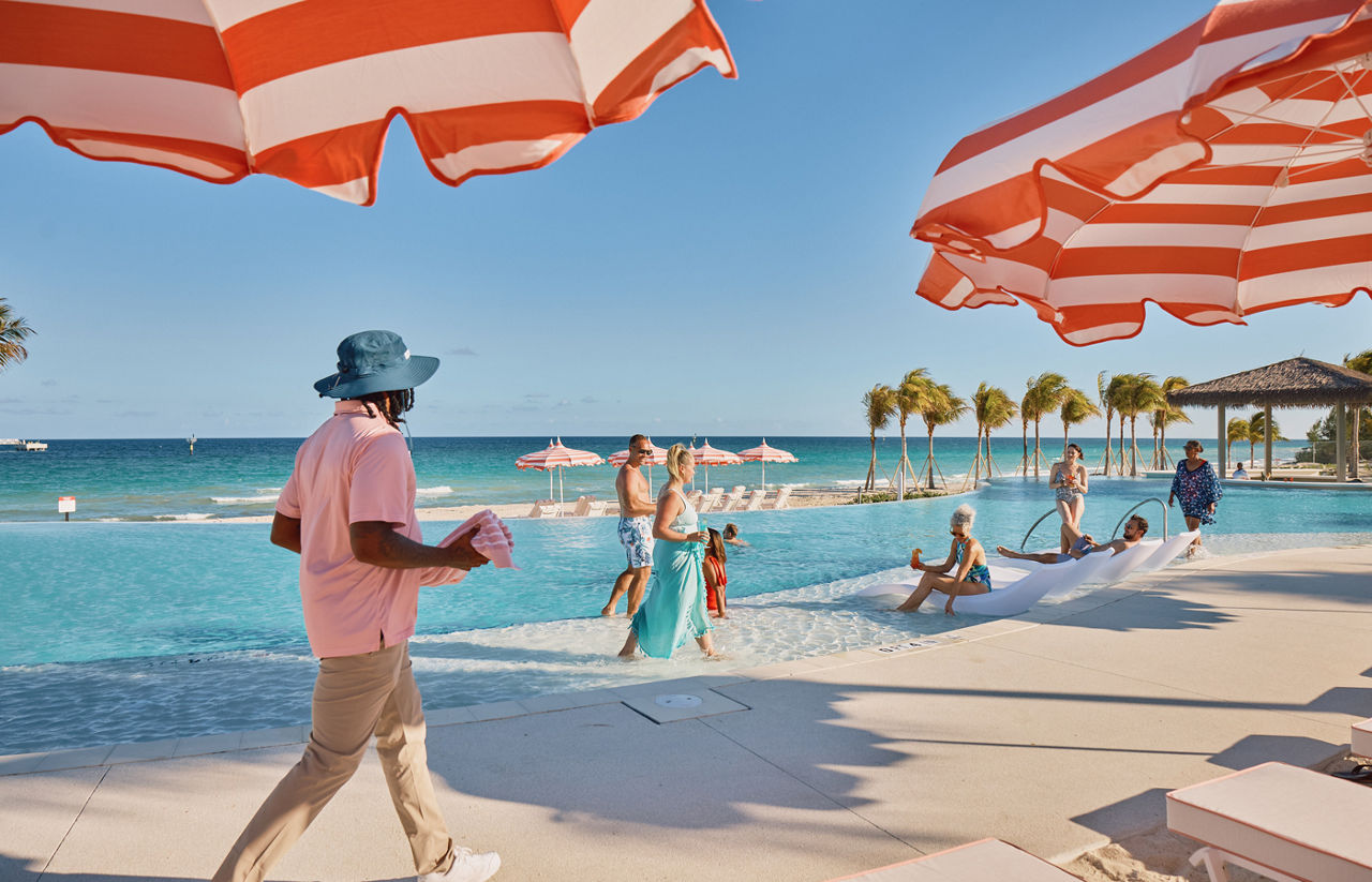 Tropical poolside with striped umbrellas on Celebration Key