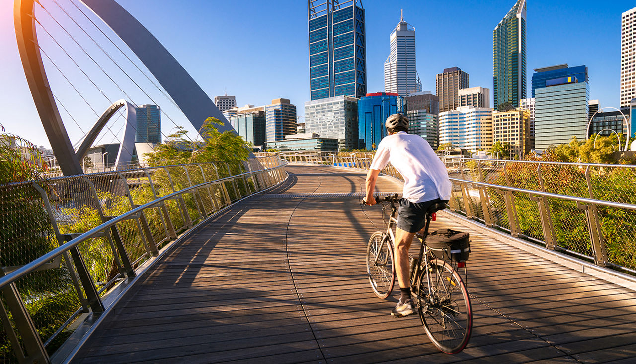 A man cycling on an elizabeth bridge in Perth city, western, Austrakia, this image can use for bike, sport, relax, healthy concept