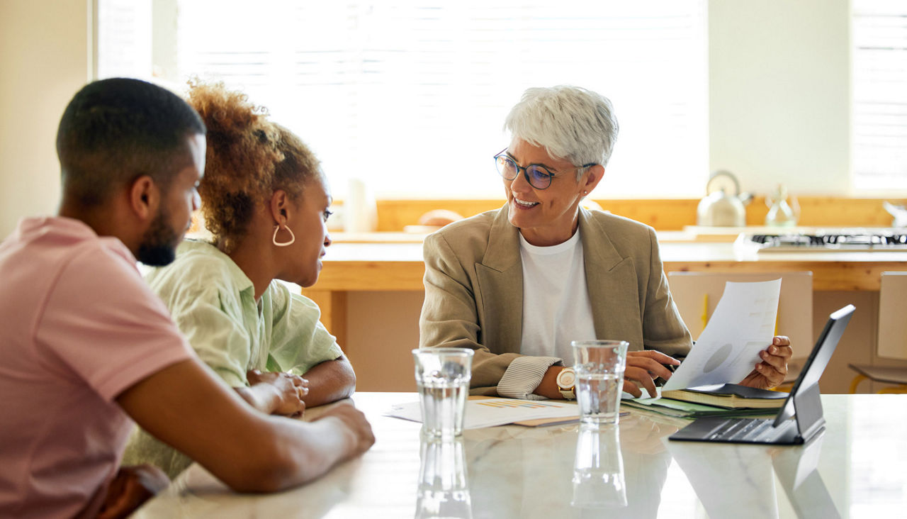 Finance advisor discussing with couple at home