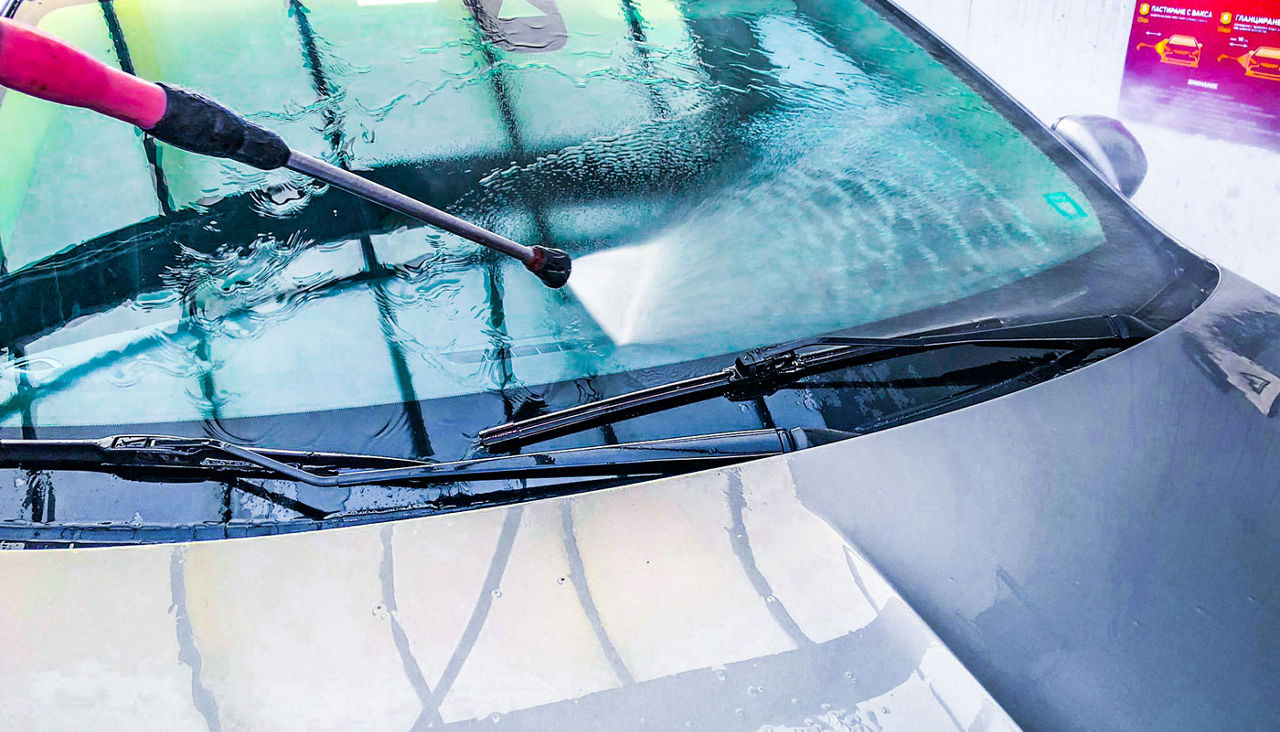 using a cleaning wand at a Self-Service Car Wash