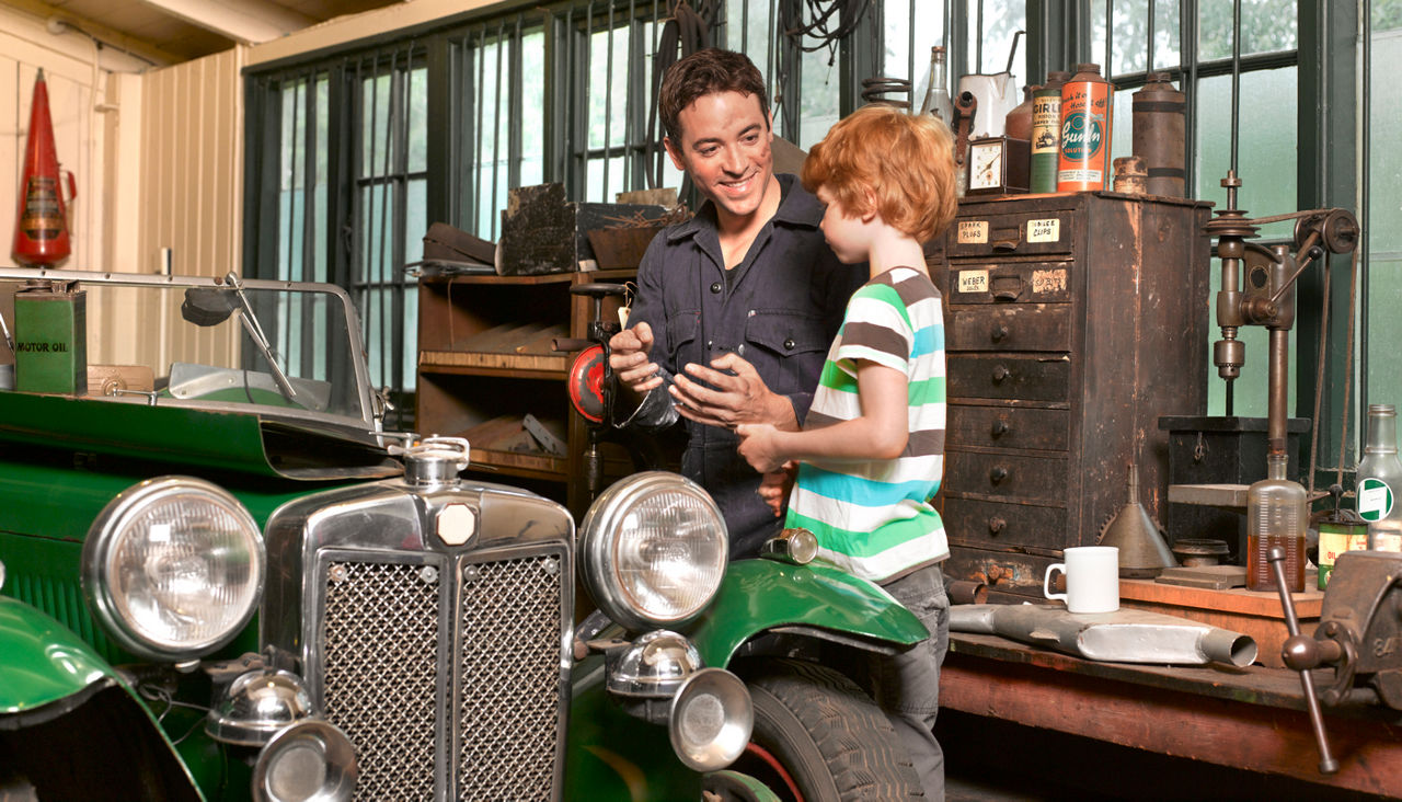 Father and son with classic car