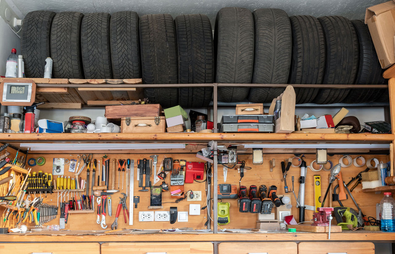 Spare season tires on storage shelf rack in garage