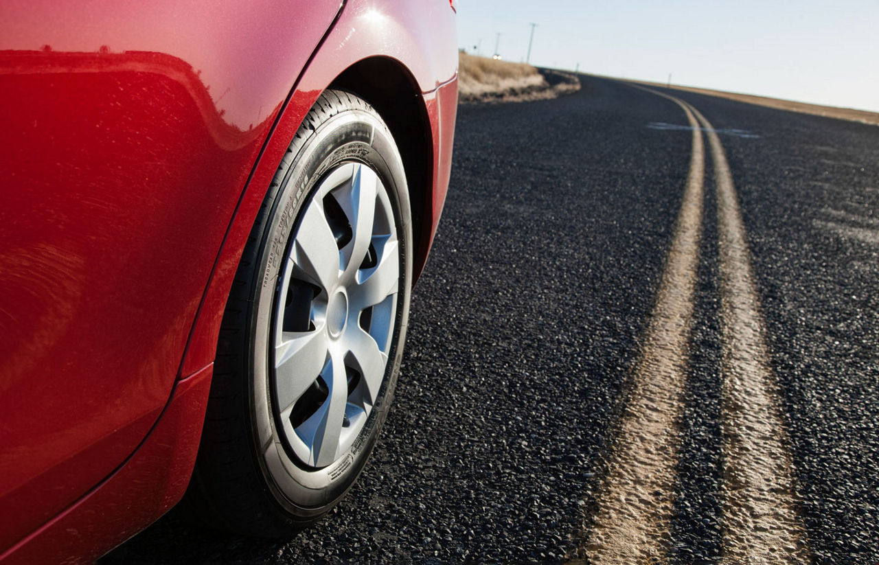 red car riding on the road