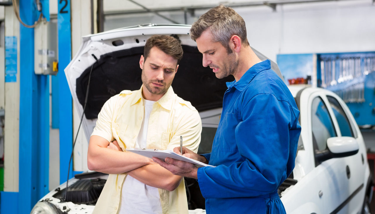 Customer listening to his mechanic
