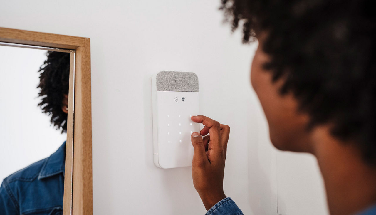 Woman activating home security system