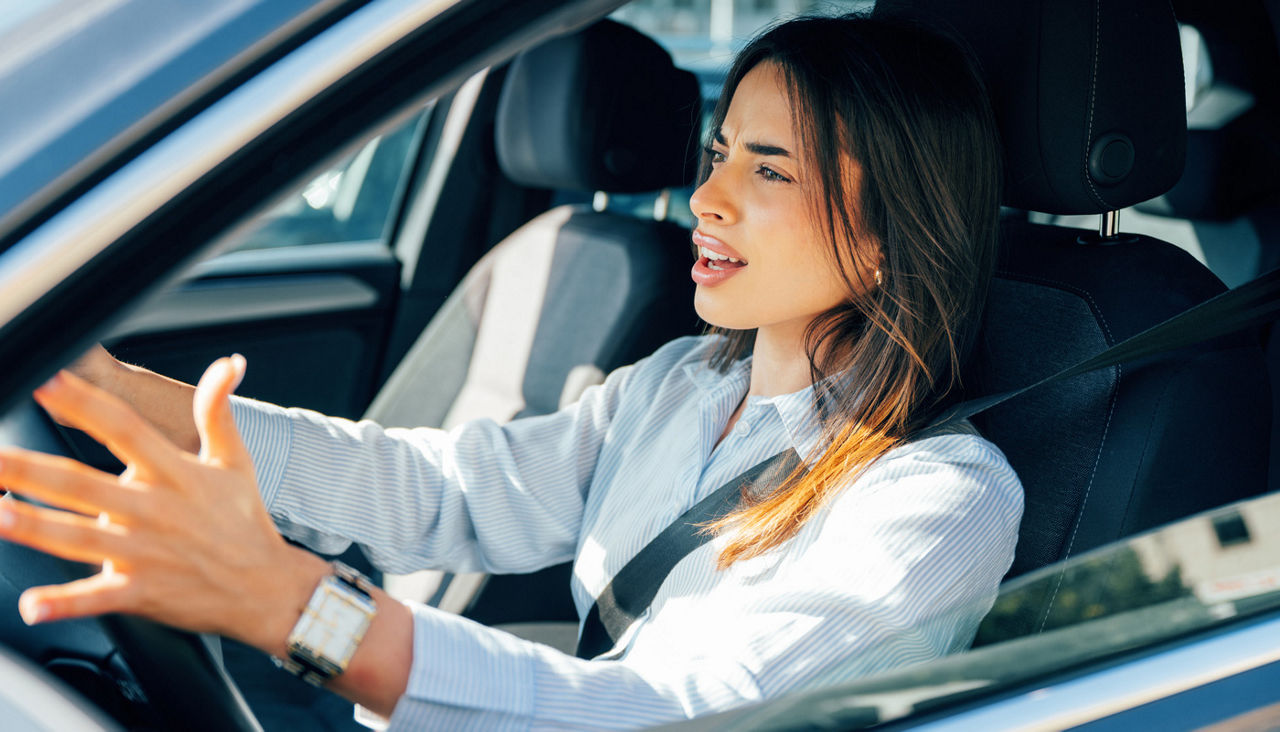 Young woman driving car in the city