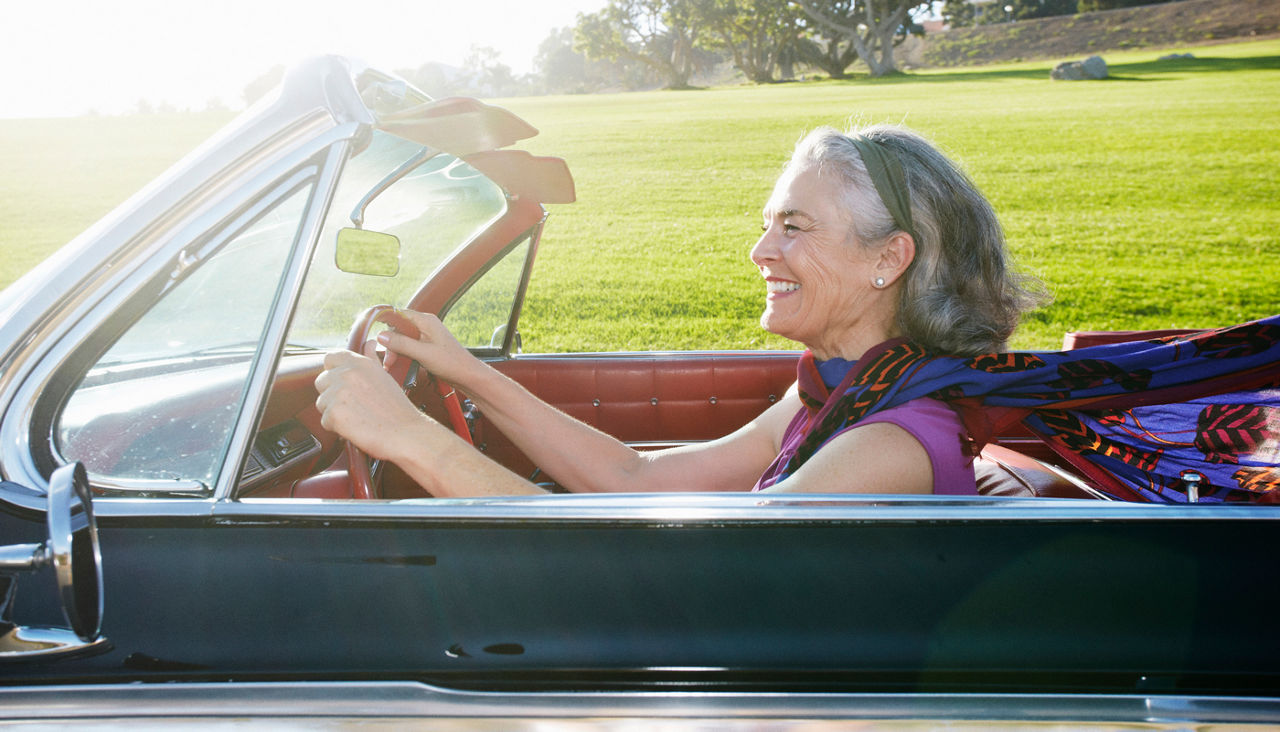 Woman driving classic convertible
