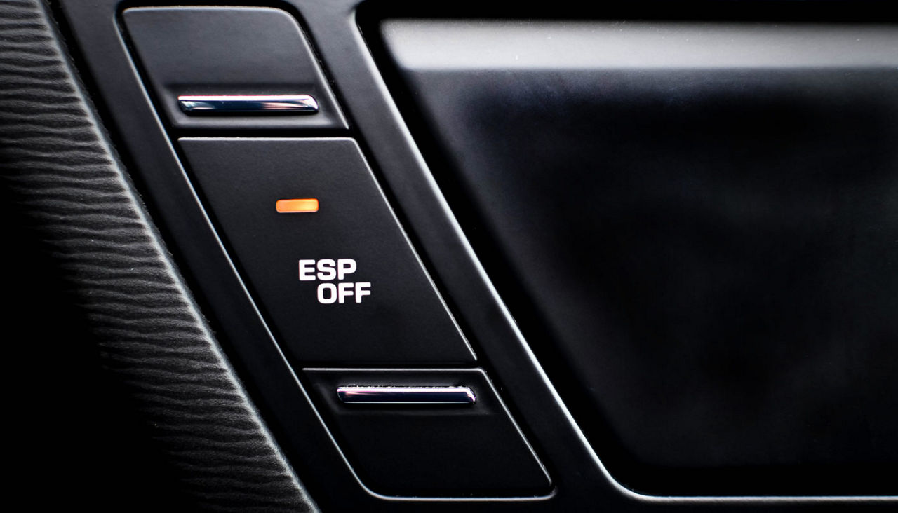 Close up inside car, button to disable traction control ESP