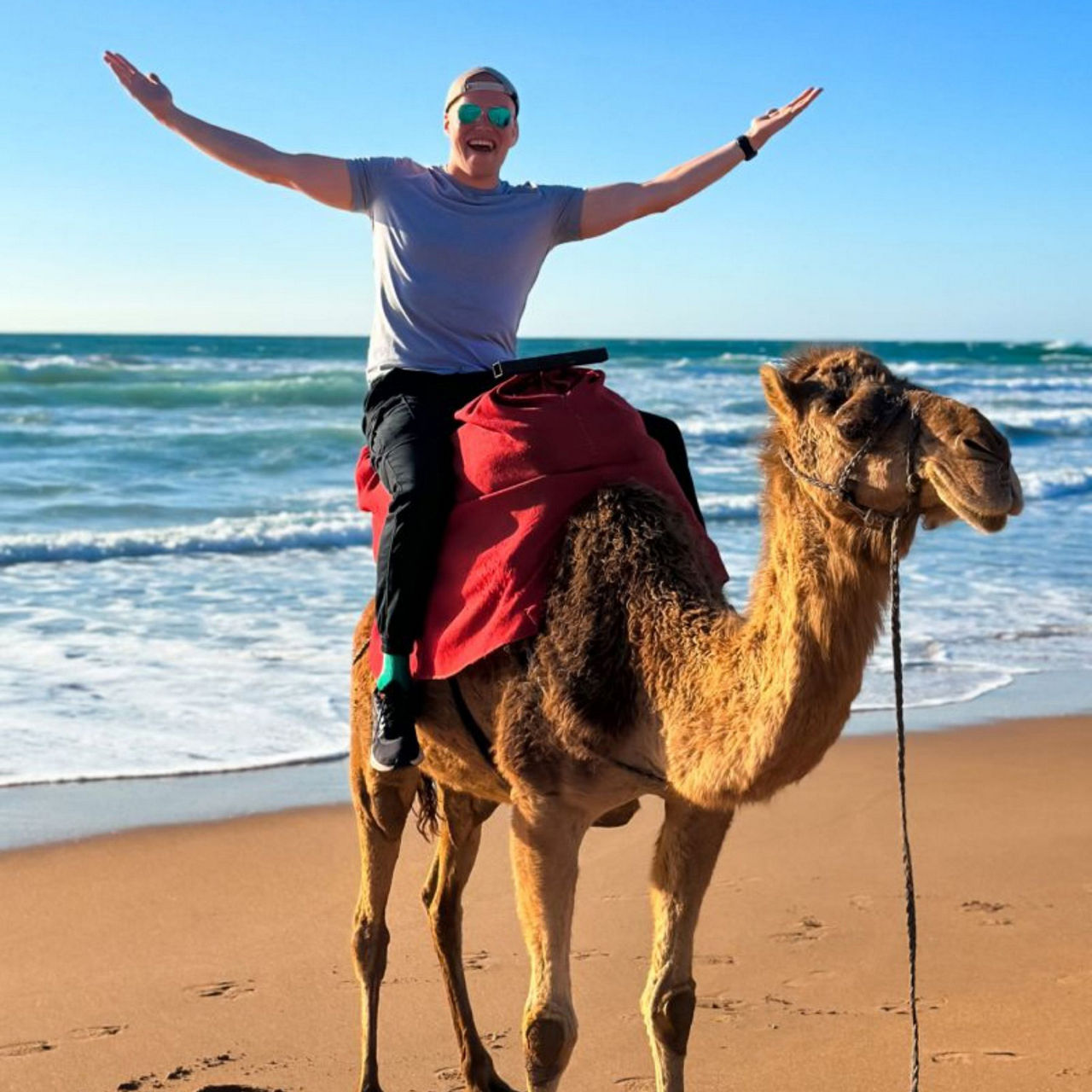 You man on a camel on an Australian beach