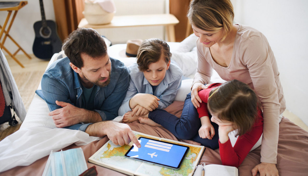 Family with small children at home planning spring break vacation