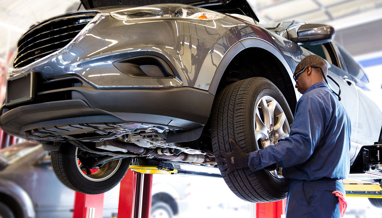 AAA Car Care Plus tech installing tires on a car on a lift