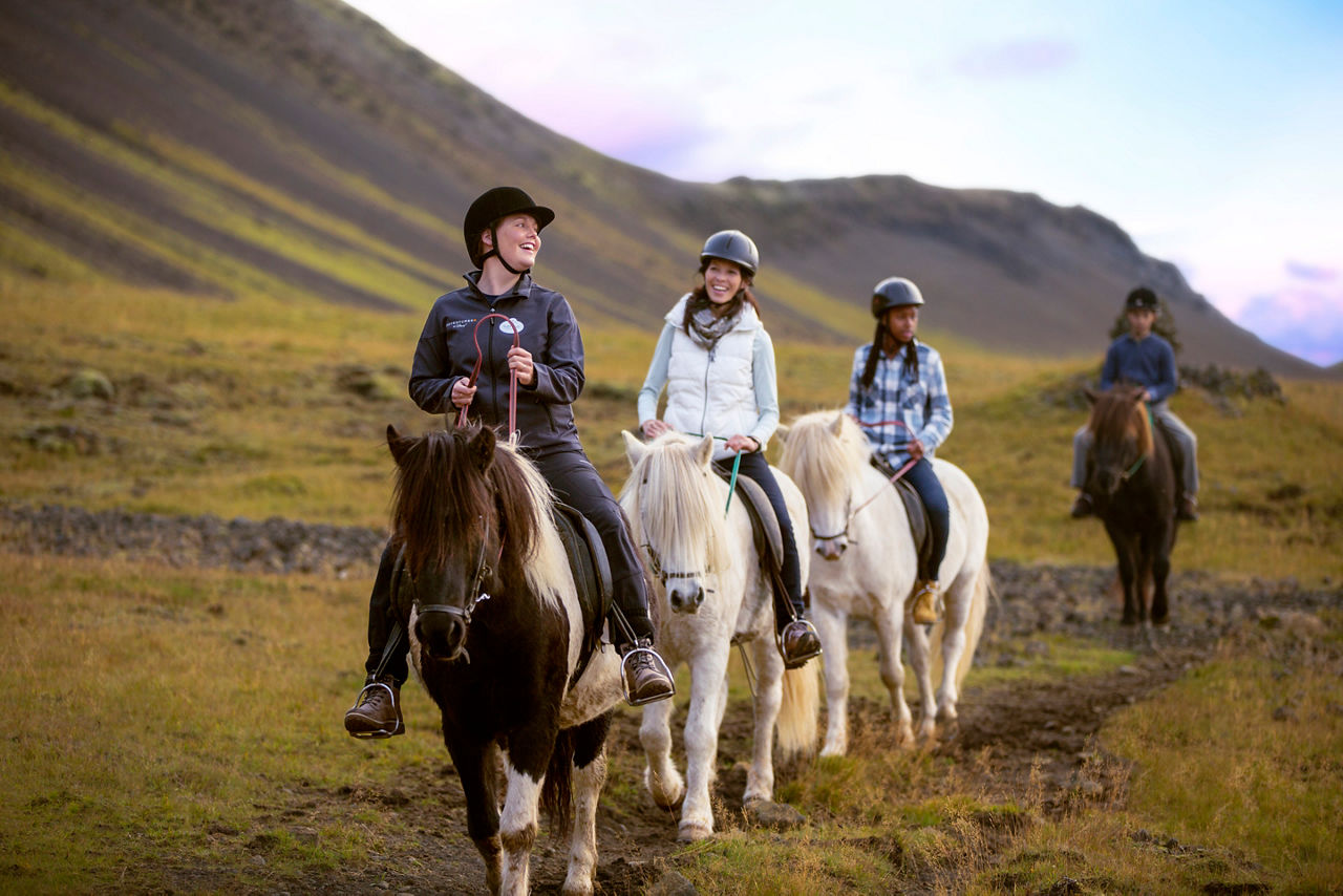 Adventure guide with guests horseback riding 