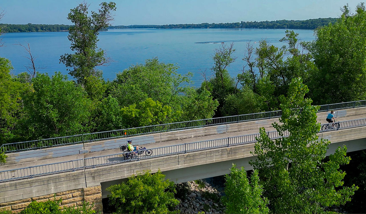 Road by Lake Geneva with trees and lake in the background.