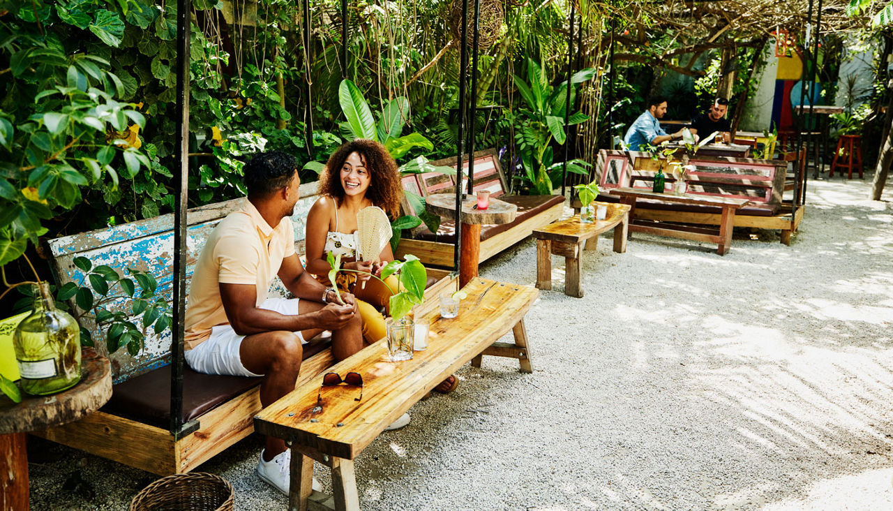 A couple sitting at an outdoor cafe in the Caribbean