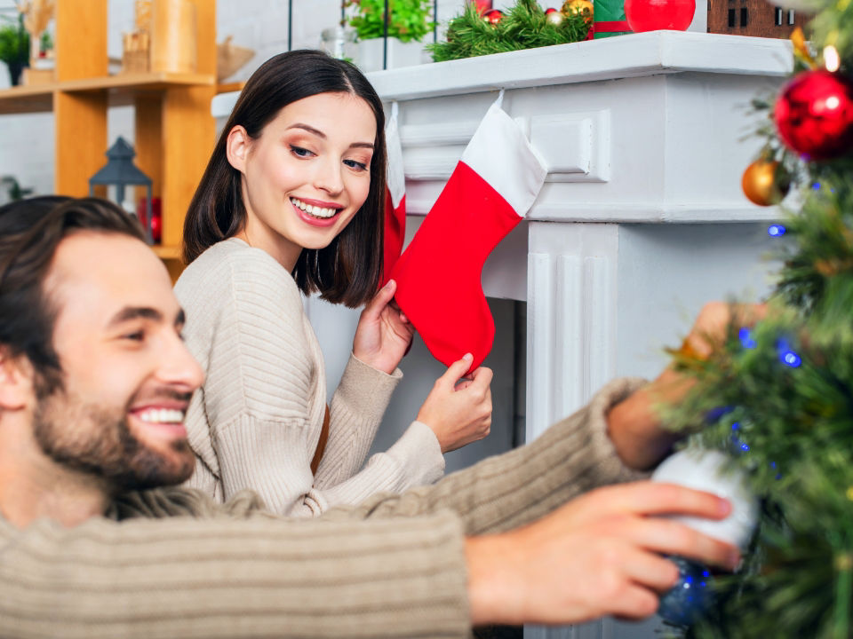 Couple decorating for Christmas holiday