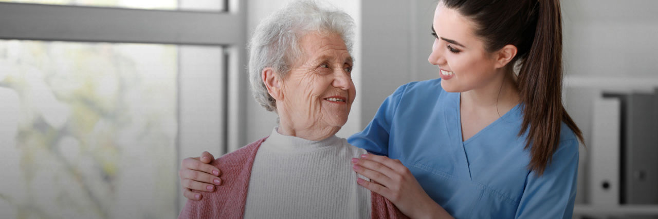 Elderly woman beign cared for by a nurse