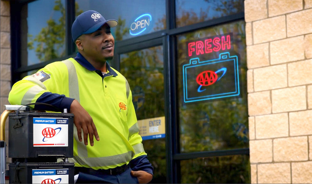 AAA man with a AAA branded car battery