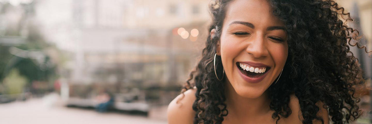Woman standing outside smiling