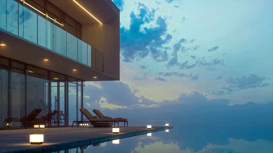 Luxurious hotel with private infinity pool and chaise lounges at summer in dusk.
