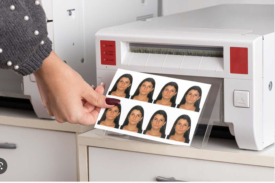 Passport photos being picked from the printer.