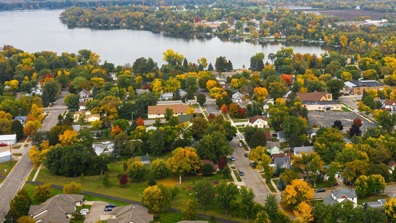 An aerial view of Sauk Centre, MN with a lake in the background.