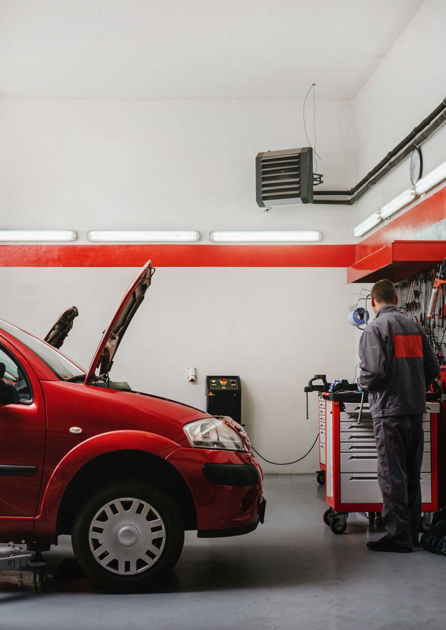 mechanic working on a red car