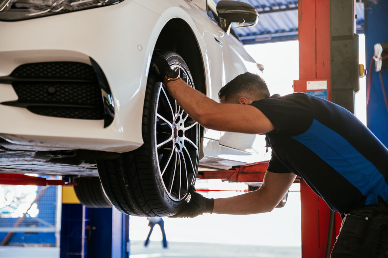 mechanic replacing a tire on a car