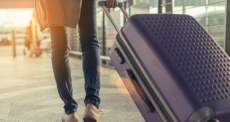 Woman with luggage in airport.