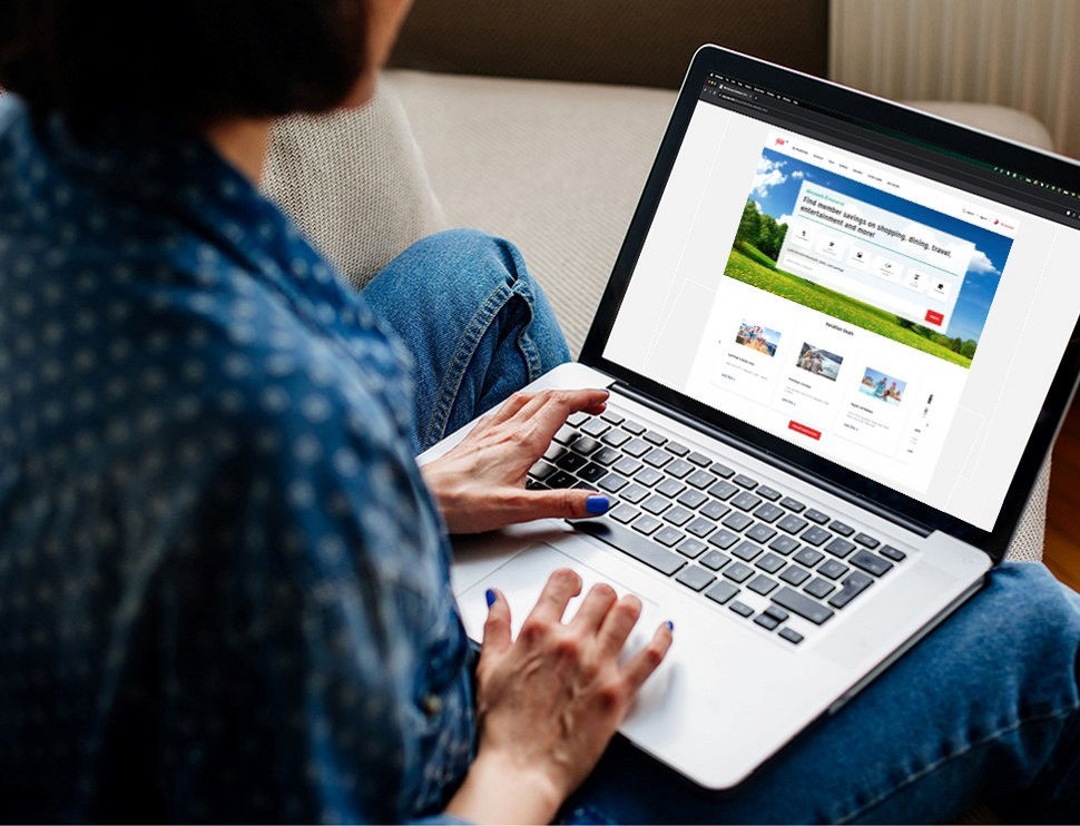 Woman booking her cruise vacation with AAA on her laptop