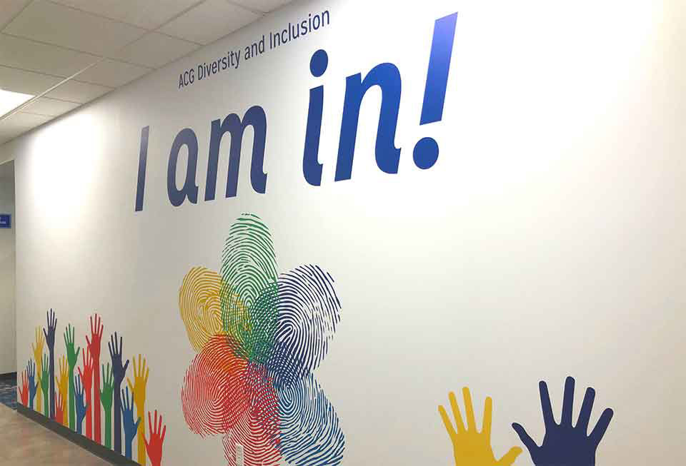 acg diversity and inclusion wall mural saying i am in with hands reaching towards the sky