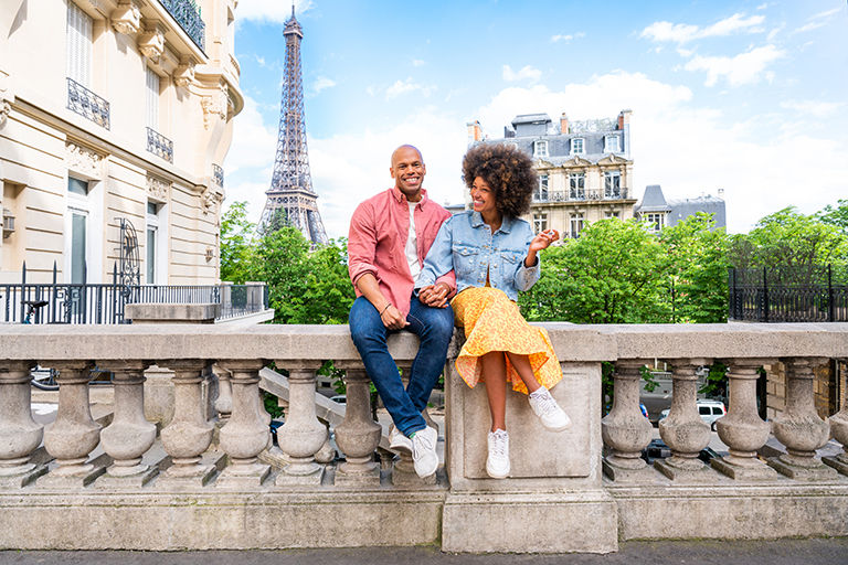 Cheerful happy couple in love, visiting Paris city centre and Eiffel Tower.