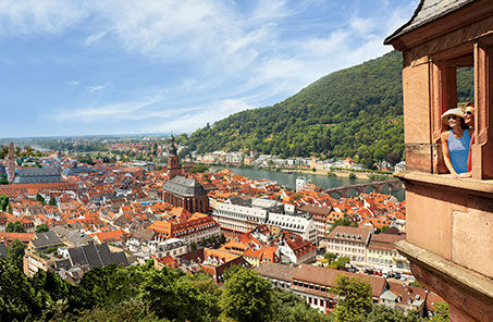 lady looking out a tower on a thriving city