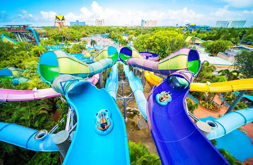 Arial view of two waterslides with people tubing down them at aquatica waterpark in seaworld.