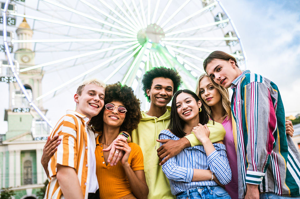 Multiracial young people together meeting and social gathering - Group of friends with mixed races having fun outdoors in the city- Friendship and lifestyle concepts