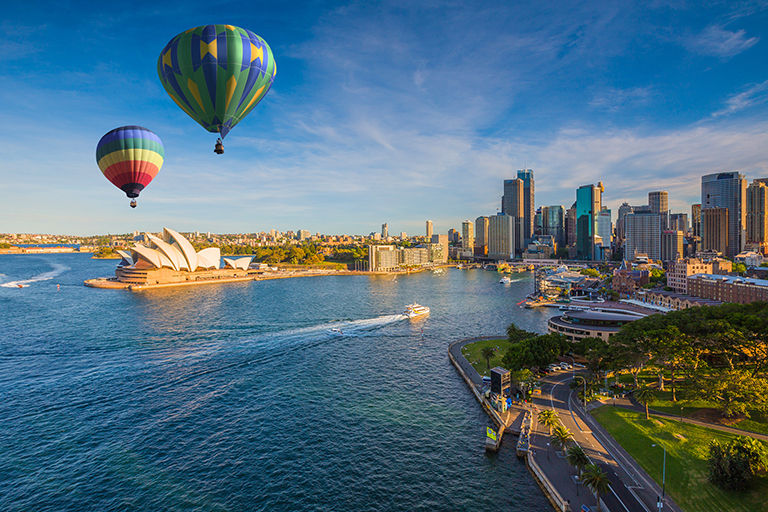 Hot air balloon over Sydney bay in evening, Sydney, Australia.