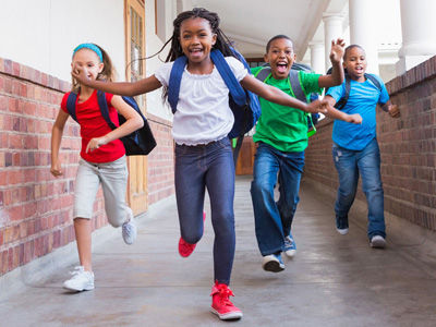 Kids excited to be back to school running to class