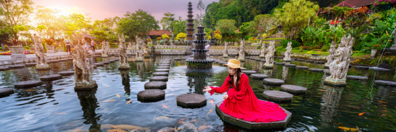 Woman in Bali on a steppingstone in a fountain