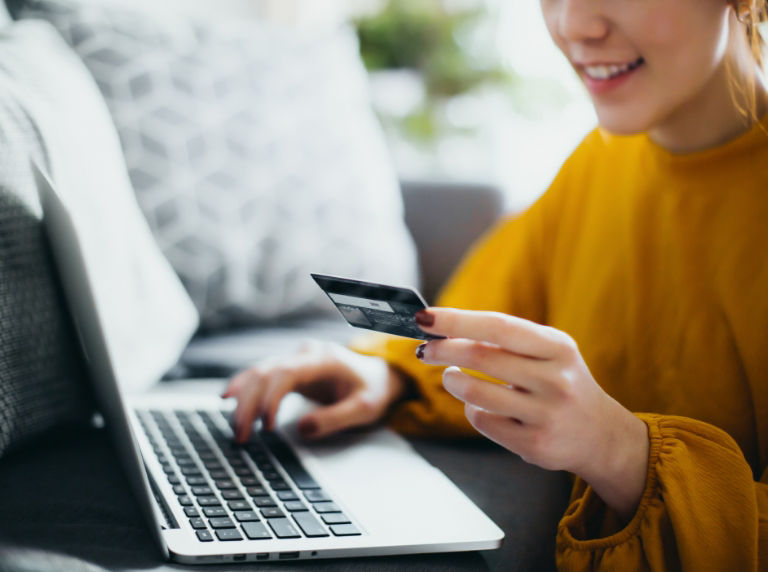 Woman banking online with credit card