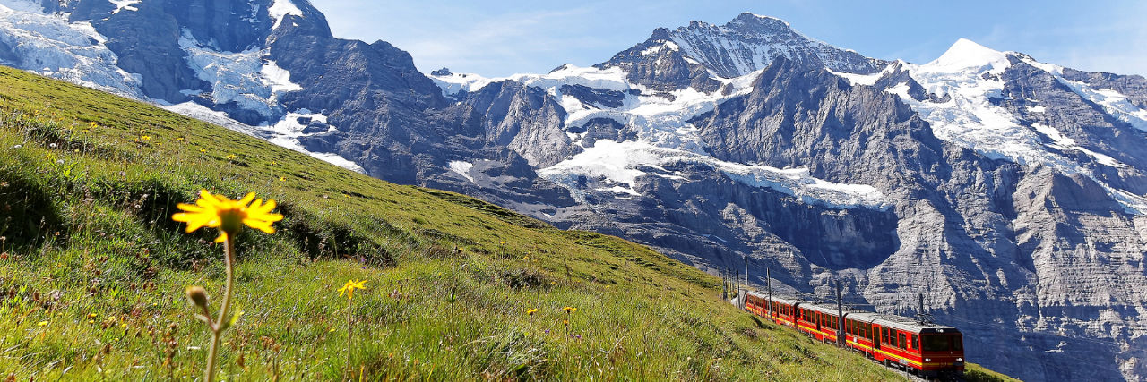Railbookers Train going through Switzerland mountains