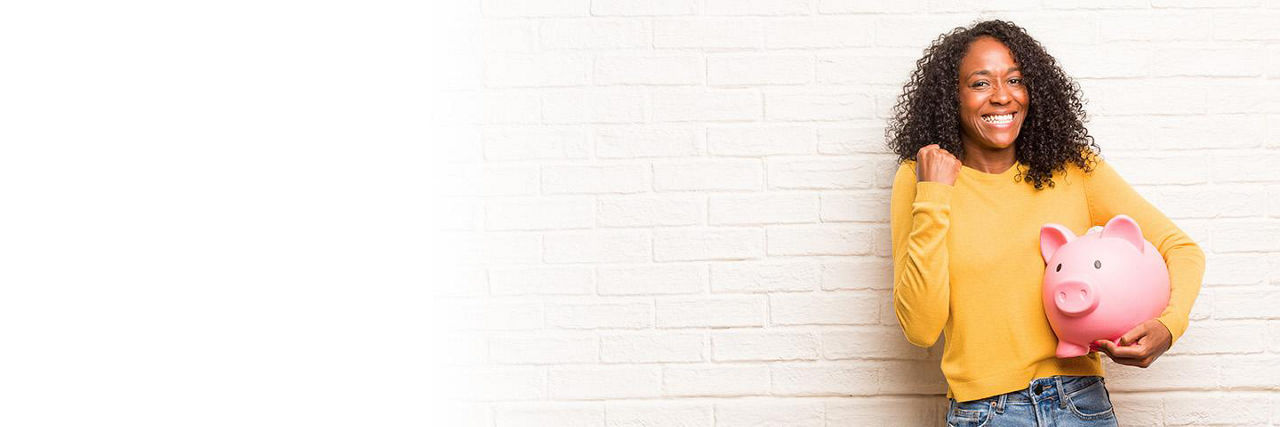 Woman holding a piggy bank and smiling