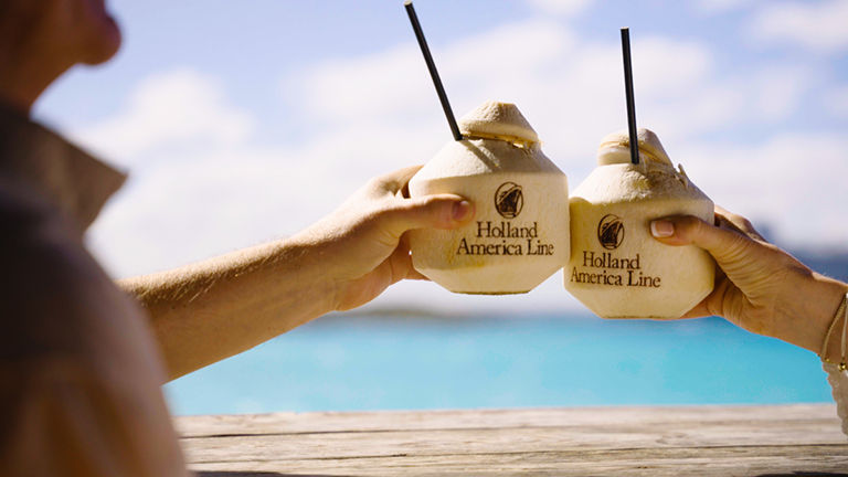 Guests enjoying personalized service on a Holland America Line cruise booked through AAA