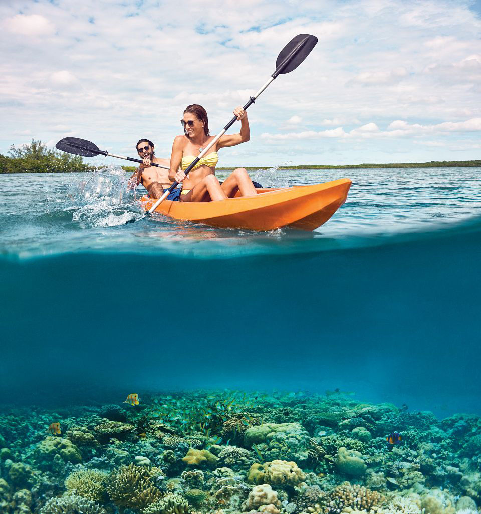 Couple kayaking crystal blue waters of Princess Cays with Princess Cruises.