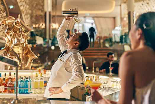 Bartender on celebrity cruise ship performs unique trick why preparing guests drink.