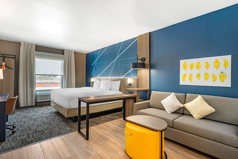 luxury AAA hotel with woman in bathrobe looking out the window