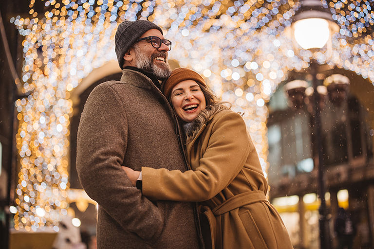 Mature couple in the city walking and having fun on winter day.