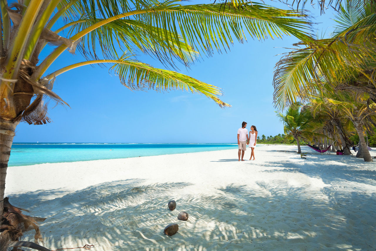 Couple walking on the beach.