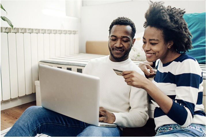 Couple making payment online with their AAA Visa.